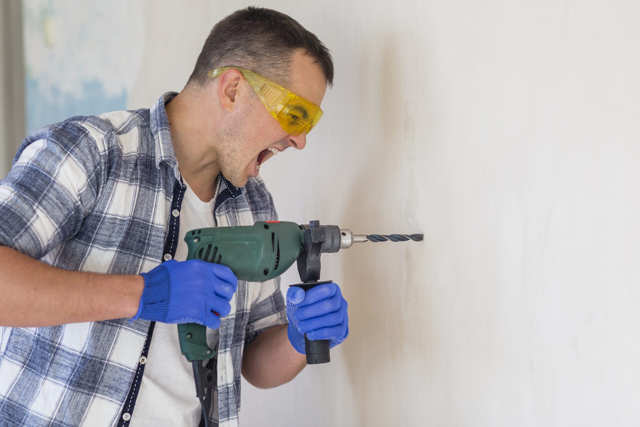 Confident man using a drill.
